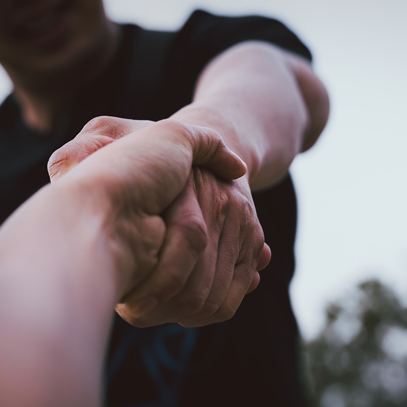 Help concept hands reaching out to help each other